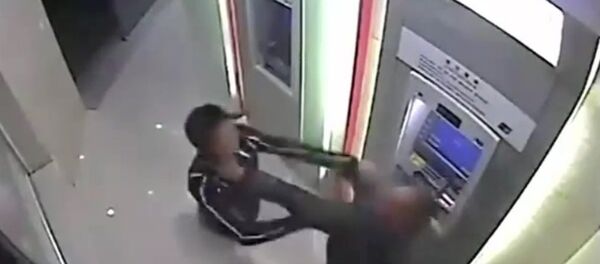 Robber beaten by victim in ATM room Robber beaten by victim in ATM room - Sputnik International