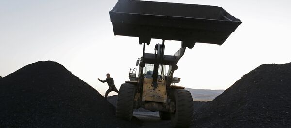 A driver gets off a loading vehicle at local businessman Sun Meng's small coal depot near a coal mine of the state-owned Longmay Group on the outskirts of Jixi, in Heilongjiang province, China, October 23, 2015 A driver gets off a loading vehicle at local businessman Sun Meng's small coal depot near a coal mine of the state-owned Longmay Group on the outskirts of Jixi, in Heilongjiang province, China, October 23, 2015 - Sputnik International
