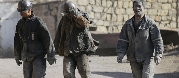 Miners walk at a coal mine from the state-owned Longmay Group on the outskirts of Jixi, in Heilongjiang province, China, October 24, 2015 - Sputnik International