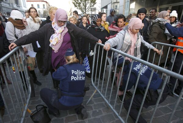 Residents of the Brussels suburb of Molenbeek are searched by police vefore taking part in a memorial gathering to honour the victims of the recent deadly Paris attacks, in Brussels, Belgium, November 18, 2015 Residents of the Brussels suburb of Molenbeek are searched by police vefore taking part in a memorial gathering to honour the victims of the recent deadly Paris attacks, in Brussels, Belgium, November 18, 2015 - Sputnik International