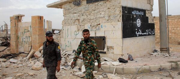 Syrian government forces walk past a building bearing an image on the wall with Islamic writing and reading in Arabic the Islamic State in the village of Jabboul on the eastern outskirts of the northern Syrian city of Aleppo after taking control of the village from Islamic State (IS) group islamists on October 24, 2015 Syrian government forces walk past a building bearing an image on the wall with Islamic writing and reading in Arabic the Islamic State in the village of Jabboul on the eastern outskirts of the northern Syrian city of Aleppo after taking control of the village from Islamic State (IS) group islamists on October 24, 2015 - Sputnik International