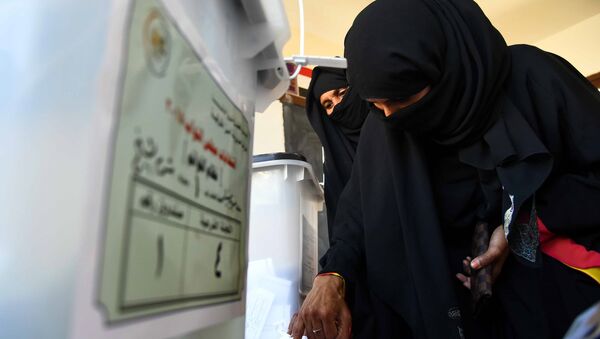 An Egyptian woman dips her finger in ink after casting her ballot at a polling station in the Red Sea resort of Sharm el-Shiekh on November 22, 2015, on the first day of the second and final round of the country's parliamentary elections - Sputnik International
