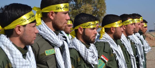 Fighters from the Iraqi Imam Ali Brigade, belonging to the Badr Organisation headed by former Iraqi Transport Minister Hadi al-Amiri, take part in a graduation ceremony in Taza Khurmatu, 20 kms south of Kirkuk, on February 26, 2015. - Sputnik International