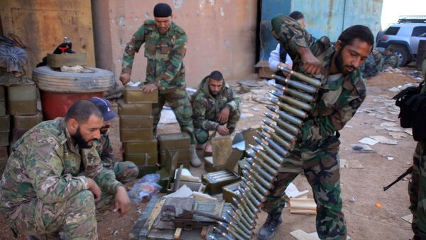 Syrian pro-government forces prepare their weapons at a train station in the area of Arkile near the airport of Kweyris, in the northern Syrian province of Aleppo, on November 20, 2015 - Sputnik International