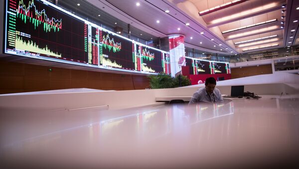 A man works on the trading floor at the Shanghai Stock Exchange in the Lujiazui Financial district of Shanghai on September 22, 2015 - Sputnik International