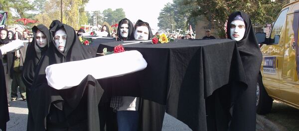 Protesters prepare to march to Fort Benning's front gate Sunday, Nov.18, 2001, in Columbus, Ga., to protest a former Army school they blame for alleged human rights violations against Latin American civilians. Protesters prepare to march to Fort Benning's front gate Sunday, Nov.18, 2001, in Columbus, Ga., to protest a former Army school they blame for alleged human rights violations against Latin American civilians. - Sputnik International