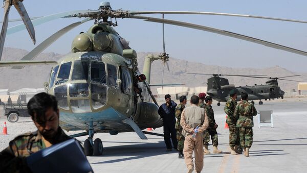 A group of Afghan Nationl Army Air Corps personnel gather beside the Russian Mi-17 transport helicopter in Kandahar air base on October 12, 2009 - Sputnik International