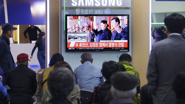 South Koreans watch a TV news program showing North Korean leader Kim Jong Un, third from right, during a ceremony to mark the 70th anniversary of the country's ruling party in Pyongyang, at Seoul Railway Station in Seoul, South Korea. Saturday, Oct. 10, 2015 - Sputnik International
