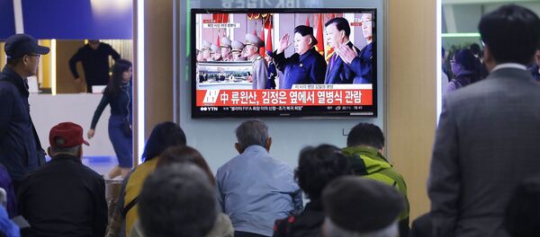 South Koreans watch a TV news program showing North Korean leader Kim Jong Un, third from right, during a ceremony to mark the 70th anniversary of the country's ruling party in Pyongyang, at Seoul Railway Station in Seoul, South Korea. Saturday, Oct. 10, 2015 - Sputnik International