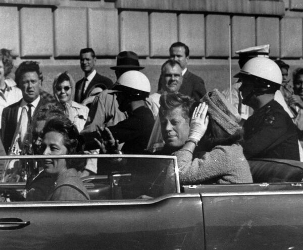 President John F. Kennedy is seen riding in motorcade approximately one minute before he was shot in Dallas, Tx., on Nov. 22, 1963. In the car riding with Kennedy are Mrs. Jacqueline Kennedy, right, Nellie Connally, left, and her husband, Gov. John Connally of Texas. President John F. Kennedy is seen riding in motorcade approximately one minute before he was shot in Dallas, Tx., on Nov. 22, 1963. In the car riding with Kennedy are Mrs. Jacqueline Kennedy, right, Nellie Connally, left, and her husband, Gov. John Connally of Texas. - Sputnik International