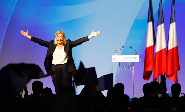 France’s far-right National Front president Marine Le Pen, center, surrounded by members, waves to supporters after her speech during their meeting in Marseille, southern France, Saturday, Sept. 6, 2015. France’s far-right National Front president Marine Le Pen, center, surrounded by members, waves to supporters after her speech during their meeting in Marseille, southern France, Saturday, Sept. 6, 2015. - Sputnik International