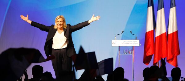 France’s far-right National Front president Marine Le Pen, center, surrounded by members, waves to supporters after her speech during their meeting in Marseille, southern France, Saturday, Sept. 6, 2015. France’s far-right National Front president Marine Le Pen, center, surrounded by members, waves to supporters after her speech during their meeting in Marseille, southern France, Saturday, Sept. 6, 2015. - Sputnik International