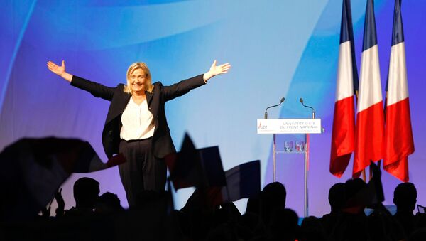 France’s far-right National Front president Marine Le Pen, center, surrounded by members, waves to supporters after her speech during their meeting in Marseille, southern France, Saturday, Sept. 6, 2015. - Sputnik International