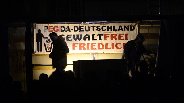 Pegida founder Lutz Bachmann is silhouetted during a demonstration of PEGIDA (Patriotic Europeans against the Islamization of the West) in Dresden, eastern Germany, Monday, Nov. 2, 2015. - Sputnik International