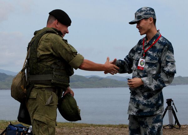 Russian and Chinese servicemen shake hands during the Russian-Chinese drill Naval Interaction-2015 at the Klerk testing grounds in Russia's Primorye Territory. Russian and Chinese servicemen shake hands during the Russian-Chinese drill Naval Interaction-2015 at the Klerk testing grounds in Russia's Primorye Territory. - Sputnik International