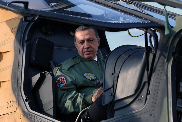 In this Tuesday, June 10, 2014 photo, Turkish Prime Minister Recep Tayyip Erdogan sits in the pilot's sesat during a presentation for the Turkish-made military attack helicopter, T129 ATAK, outside Ankara, Turkey In this Tuesday, June 10, 2014 photo, Turkish Prime Minister Recep Tayyip Erdogan sits in the pilot's sesat during a presentation for the Turkish-made military attack helicopter, T129 ATAK, outside Ankara, Turkey - Sputnik International