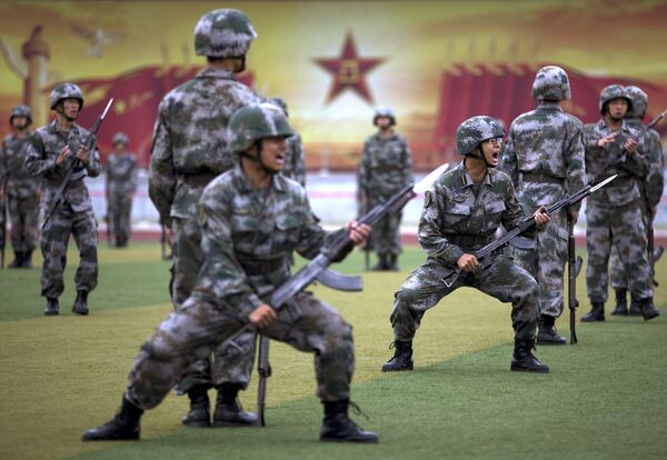Chinese People's Liberation Army cadets shout as they take part in a bayonet drills at the PLA's Armoured Forces Engineering Academy Base, on the outskirt of Beijing, China Tuesday, July 22, 2014. - Sputnik International