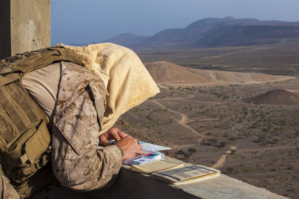 A 26th Marine Expeditionary Unit Maritime Raid Force Marine finds target locations on a map prior to conducting a joint terminal attack control training exercise at an observation post in Djibouti, Africa, May 30, 2013 A 26th Marine Expeditionary Unit Maritime Raid Force Marine finds target locations on a map prior to conducting a joint terminal attack control training exercise at an observation post in Djibouti, Africa, May 30, 2013 - Sputnik International