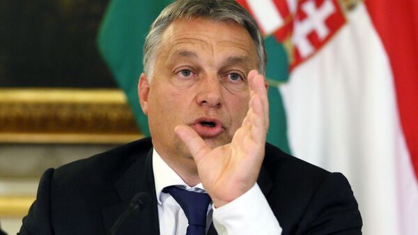 Hungarian Prime Minister Viktor Orban addresses the media on the occasion of a meeting with Austrian Chancellor Werner Faymann and Vice Chancellor Reinhold Mitterlehner at the Hungarian Embassy in Vienna, Austria, Friday, Sept. 25, 2015. - Sputnik International