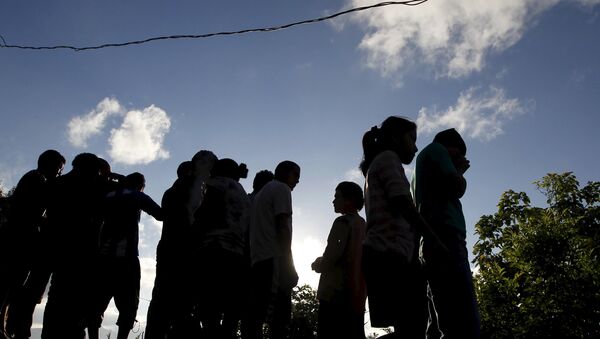 People stand near at a crime scene where seven men were killed, in Tegucigalpa, Honduras - Sputnik International