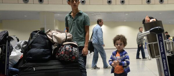 Syrian citizens who have been evacuated by a plane of the Russian Ministry for Civil Defense, Emergencies and Disaster Relief from Latakia, Syria, at Moscow's Domodedovo airport. Syrian citizens who have been evacuated by a plane of the Russian Ministry for Civil Defense, Emergencies and Disaster Relief from Latakia, Syria, at Moscow's Domodedovo airport. - Sputnik International