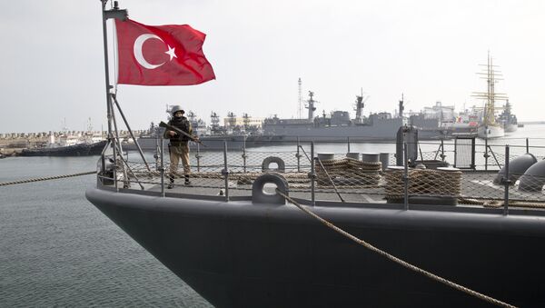 A Turkish marine serviceman stands on the deck of a Turkish navy TCG Turgutreis vessel in the Black Sea port. - Sputnik International