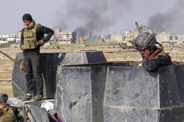 Iraq forces supported by U.S.-led coalition airstrikes advance their position during clashes with Islamic State group in the western suburbs of Ramadi, the capital of Iraq's Anbar province. - Sputnik International