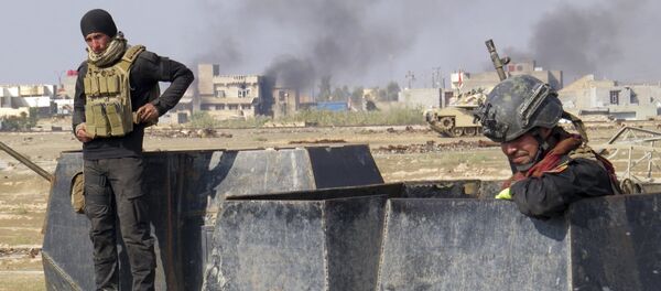 Iraq forces supported by U.S.-led coalition airstrikes advance their position during clashes with Islamic State group in the western suburbs of Ramadi, the capital of Iraq's Anbar province. - Sputnik International