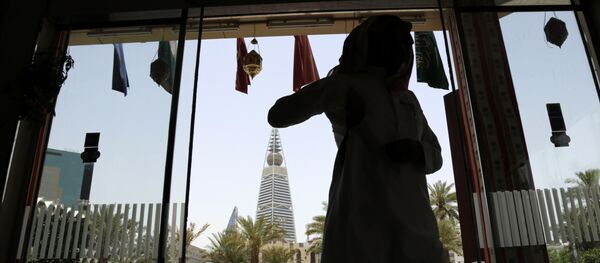 A Saudi man enters a hotel decorated for the Muslim holly month of Ramadan, Riyadh, Saudi Arabia, Monday, June 15, 2015. - Sputnik International