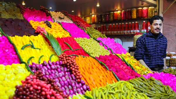 Stand offering various sourts of pickeled and colored vegetables at a covered street market in central Damascus - Sputnik International