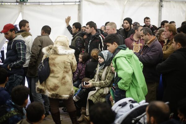 Migrants wait for registration at the central registration center for refugees and asylum seekers in Berlin Migrants wait for registration at the central registration center for refugees and asylum seekers in Berlin - Sputnik International