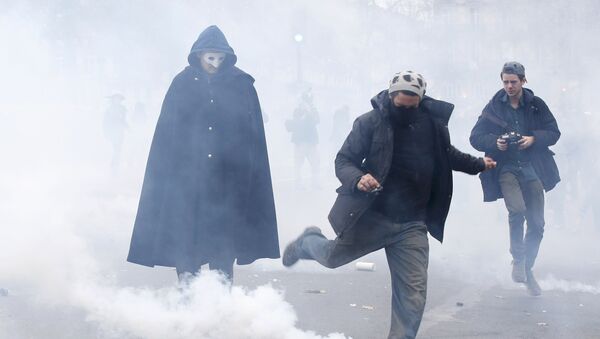 A demonstrator kicks a tear gas canister during clashes with CRS riot police near the Place de la Republique after the cancellation of a planned climate march following shootings in the French capital, ahead of the World Climate Change Conference 2015 (COP21), in Paris, France, November 29, 2015 - Sputnik International