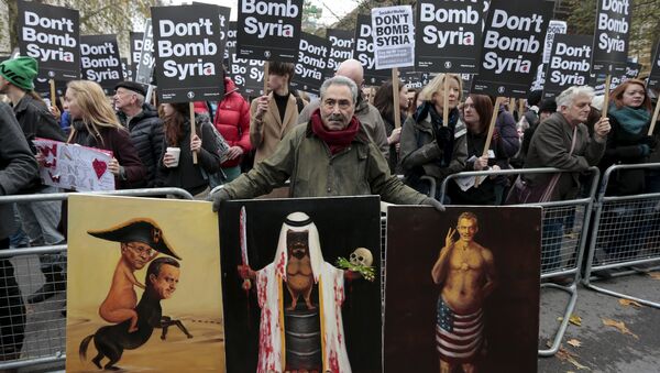 Artist Kaya Mar displays his politically-themed paintings at a rally against taking military action against Islamic State in Syria, held outside Downing Street in London, November 28, 2015 - Sputnik International