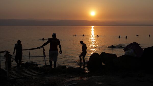 Tourists and local residents visit the Dead Sea beach, 34 miles (55 kilometers) southeast of Amman, Jordan, Friday, June 29, 2012 - Sputnik International