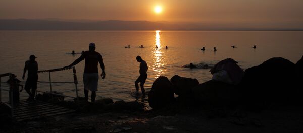 Tourists and local residents visit the Dead Sea beach, 34 miles (55 kilometers) southeast of Amman, Jordan, Friday, June 29, 2012 Tourists and local residents visit the Dead Sea beach, 34 miles (55 kilometers) southeast of Amman, Jordan, Friday, June 29, 2012 - Sputnik International