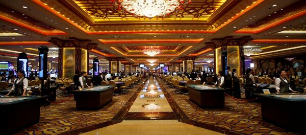Casino workers stand at gaming tables inside the Sands' newest integrated resort, Sands Cotai Central, in Macau (File) Casino workers stand at gaming tables inside the Sands' newest integrated resort, Sands Cotai Central, in Macau (File) - Sputnik International