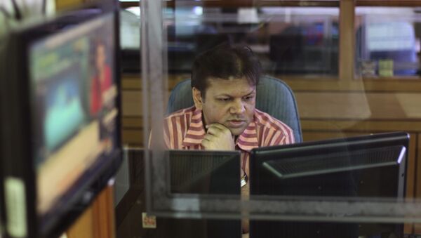 An Indian stockbroker looks at a trading terminal at a stock brokerage in Mumbai, India, Thursday, Aug. 22, 2013 - Sputnik International