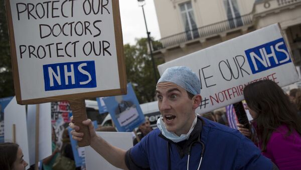A protester holds a placard at a demonstration in support of junior doctors in London, in this file photograph dated October 17, 2015 - Sputnik International