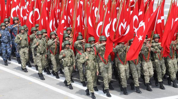 Troops parade with Turkish flags in Ankara during celebrations for the 91st anniversary of Victory Day. File photo. - Sputnik International