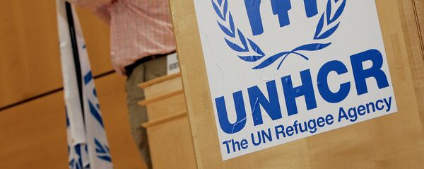 A staff installs a UNHCR flag close to a logo of UN High Commissioner for Refugees (UNHCR) prior to the opening of a two-day United Nations conference trying to boost support for Iraqis who have fled violence, 17 April 2007 at the UN Office in Geneva A staff installs a UNHCR flag close to a logo of UN High Commissioner for Refugees (UNHCR) prior to the opening of a two-day United Nations conference trying to boost support for Iraqis who have fled violence, 17 April 2007 at the UN Office in Geneva - Sputnik International