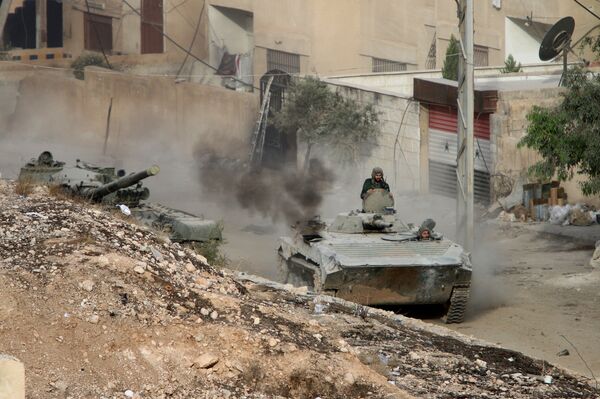 Syrian APC is followed by a tank in Harasta, northeast of Damascus, Syria, Thursday, Oct. 22, 2015 Syrian APC is followed by a tank in Harasta, northeast of Damascus, Syria, Thursday, Oct. 22, 2015 - Sputnik International