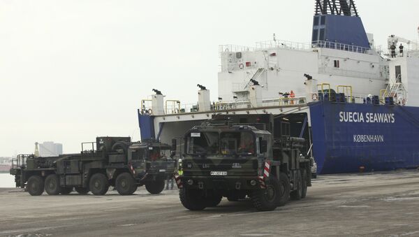 German military trucks carrying NATO's Patriot Missile Defense System to protect Turkey in case neighboring Syria launches an attack leave the port after the parts of system were unloaded in the Mediterranean city of Iskenderun, Turkey, Monday, Jan. 21, 2013 - Sputnik International