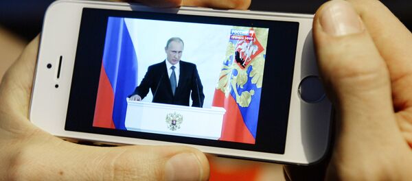 Novosibirsk resident watches the broadcast of Vladimir Putin's annual Presidential Address to Federal Assembly Novosibirsk resident watches the broadcast of Vladimir Putin's annual Presidential Address to Federal Assembly - Sputnik International