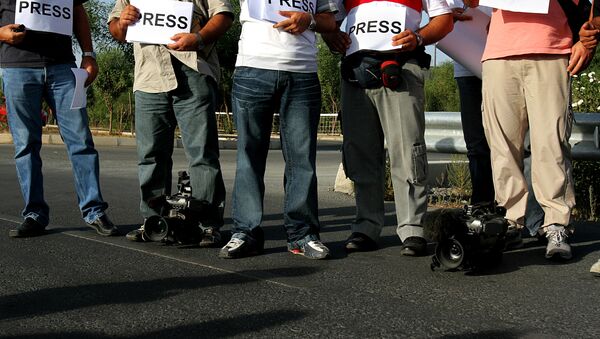 Greek Cypriot journalists and cameramen stand at the Aghios Dometios checkpoint crossing next of UN buffer zone during a peaceful protest in divided capital of Nicosia (File) - Sputnik International