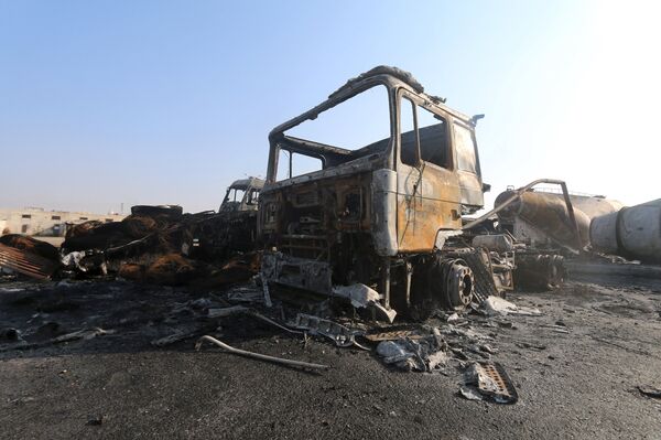 Damaged trucks are pictured after what activists said were air strikes carried out by the Russian air force, on a parking garage for cargo trucks in al-Dana town, near the Syrian-Turkish border in Idlib Governorate November 28, 2015 Damaged trucks are pictured after what activists said were air strikes carried out by the Russian air force, on a parking garage for cargo trucks in al-Dana town, near the Syrian-Turkish border in Idlib Governorate November 28, 2015 - Sputnik International