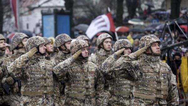 Soldiers from the Latvian army salute as they march during Independence Day military parade in Riga, Latvia, November 18, 2015 - Sputnik International