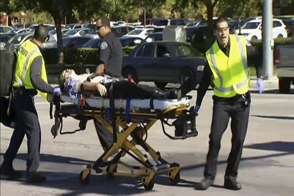 Still from video shows rescue crews tending to the injured in the intersection outside the Inland Regional Center in San Bernardino - Sputnik International