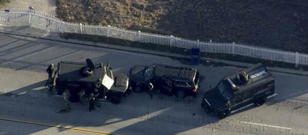 Police armored cars close in on a suspect vehicle following a shooting incident in San Bernardino. Police armored cars close in on a suspect vehicle following a shooting incident in San Bernardino. - Sputnik International