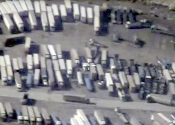 An undated still image taken from a video made available by the Russian Defense Ministry in Moscow, Russia December 2, 2015, shows the Turkish-Syrian border crossing. Russia's Defense Ministry officials displayed satellite images on Wednesday which they said showed columns of tanker trucks loading with oil at installations controlled by Islamic State in Syria and Iraq, and then crossing the border into neighboring Turkey. An undated still image taken from a video made available by the Russian Defense Ministry in Moscow, Russia December 2, 2015, shows the Turkish-Syrian border crossing. Russia's Defense Ministry officials displayed satellite images on Wednesday which they said showed columns of tanker trucks loading with oil at installations controlled by Islamic State in Syria and Iraq, and then crossing the border into neighboring Turkey. - Sputnik International