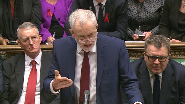 Opposition Labour Party leader, Jeremy Corbyn, center, stands as he makes a speech to lawmakers inside the House of Commons in London, during a debate on launching airstrikes against Islamic State extremists inside Syria, Wednesday, Dec. 2, 2015. - Sputnik International
